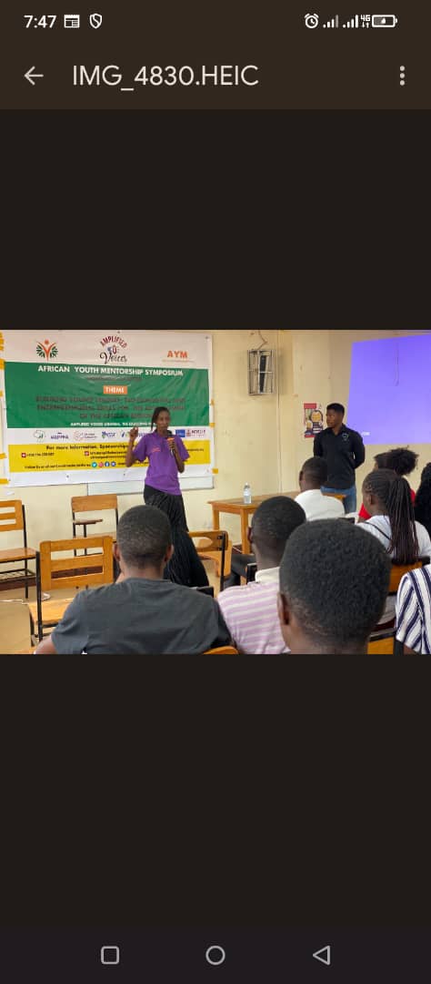A presenter and participants taking part in a symposium discussion.